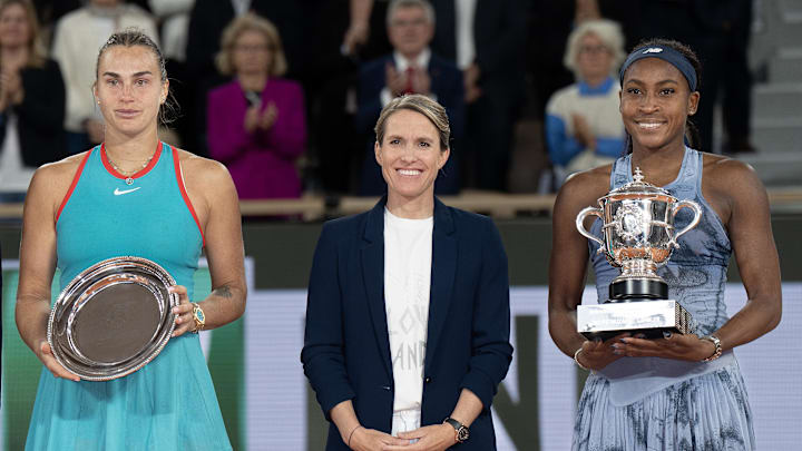 Coco Gauff of the United States poses with Aryna Sabalenka and Justin Henin after their match on day 14 at Roland Garros Stadium.