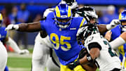 Los Angeles Rams defensive tackle Bobby Brown III tackles Philadelphia Eagles running back Saquon Barkley