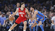 Oct 21, 2025; Oklahoma City, Oklahoma, USA; Houston Rockets center Alperen Sengun (28) drives to the basket against Oklahoma City Thunder center Chet Holmgren (7) during the first half at Paycom Center. Mandatory Credit: Alonzo Adams-Imagn Images