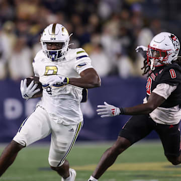 Nov 21, 2024; Atlanta, Georgia, USA; Georgia Tech Yellow Jackets wide receiver Avery Boyd (9) runs past North Carolina State Wolfpack linebacker Sean Brown (0) in the second quarter at Bobby Dodd Stadium at Hyundai Field. Mandatory Credit: Brett Davis-Imagn Images