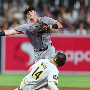 Sep 7, 2024; San Diego, California, USA; San Francisco Giants shortstop Tyler Fitzgerald (49) turns a double play on a ground ball by San Diego Padres shortstop Mason McCoy (18) during the sixth inning at Petco Park.