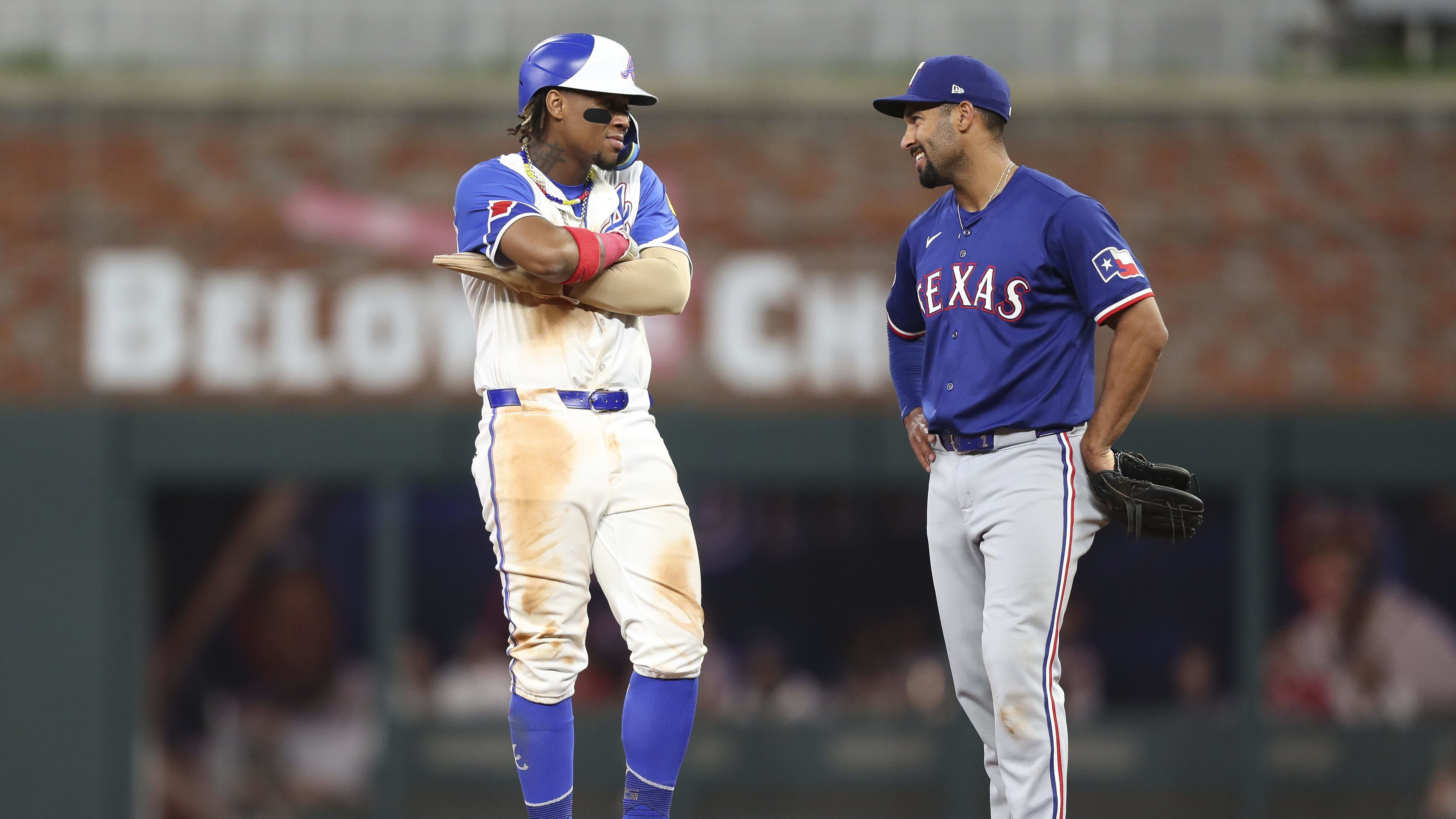Atlanta Braves right fielder Ronald Acuna Jr and Texas Rangers infielder Marcus Semien chat during the 9th inning of Saturday night's Braves victory