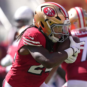 Oct 6, 2024; Santa Clara, California, USA; San Francisco 49ers running back Jordan Mason (24) carries the ball against the Arizona Cardinals during the second quarter at Levi's Stadium. Mandatory Credit: Darren Yamashita-Imagn Images