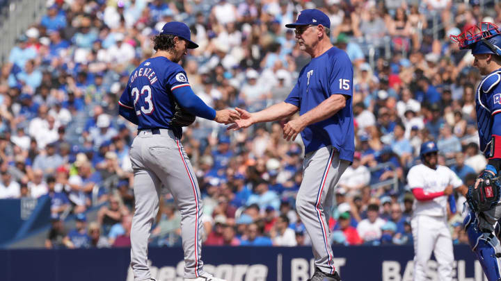 Jul 27, 2024; Toronto, Ontario, CAN; Texas Rangers starting pitcher Michael Lorenzen (23) is relieved by manager Bruce Bochy (15) against the Toronto Blue Jays during the first inning at Rogers Centre. Mandatory Credit: Nick Turchiaro-USA TODAY Sports