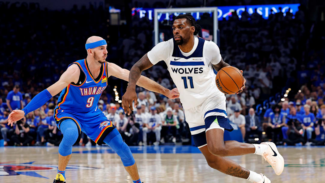 Minnesota Timberwolves center Naz Reid drives to the basket against Oklahoma City Thunder guard Alex Caruso during the second quarter in Game 5 of the Western Conference finals at Paycom Center in Oklahoma City on May 28, 2025.
