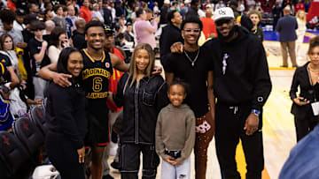 Bronny James poses for a family photo with Savannah James, Bryce Maximus James, Zhuri Nova James, and LeBron James.