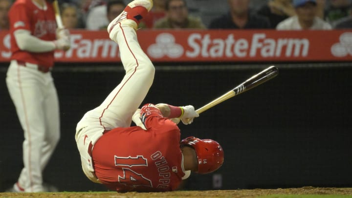 Jul 9, 2024; Anaheim, California, USA; Los Angeles Angels catcher Logan O'Hoppe (14) lands on the dirt after backing off an inside pitch in the ninth inning against the Texas Rangers at Angel Stadium. Mandatory Credit: Jayne Kamin-Oncea-USA TODAY Sports