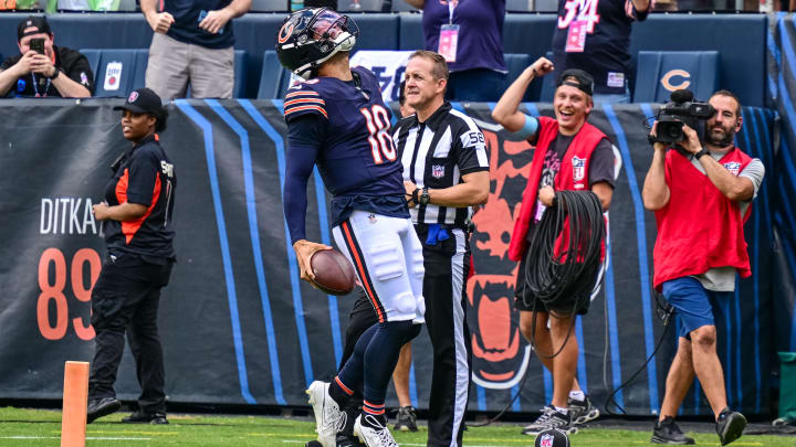 Aug 17, 2024; Chicago, Illinois, USA; Chicago Bears quarterback Caleb Williams (18) celebrates his rushing touchdown against the Cincinnati Bengals during the second quarter at Soldier Field. Mandatory Credit: Daniel Bartel-USA TODAY Sports