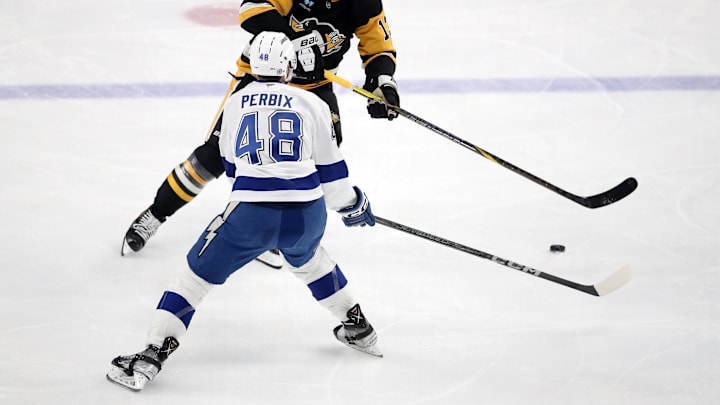 Jan 12, 2025; Pittsburgh, Pennsylvania, USA;  Pittsburgh Penguins right wing Kevin Hayes (13) skates with the puck as Tampa Bay Lightning defenseman Nick Perbix (48) defends during the second period at PPG Paints Arena. Mandatory Credit: Charles LeClaire-Imagn Images