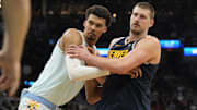 Jan 4, 2025; San Antonio, Texas, USA; San Antonio Spurs center Victor Wembanyama (1) and Denver Nuggets center Nikola Jokic (15) battle for position during an inbound pass in the second half at Frost Bank Center. Mandatory Credit: Scott Wachter-Imagn Images