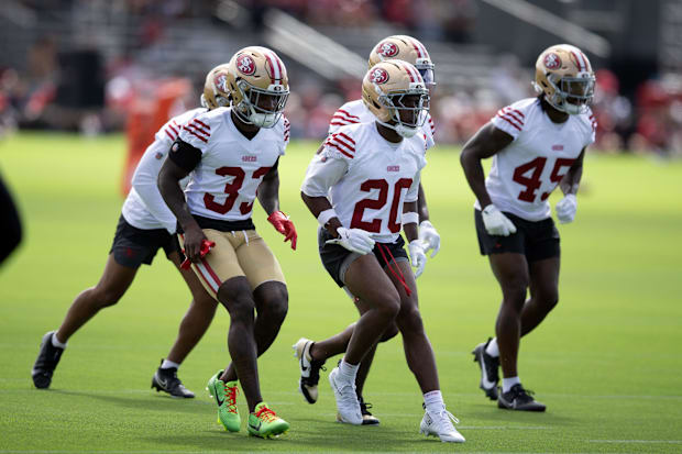 San Francisco 49ers defensive backs run drills during the first day of training camp at SAP Performance Facility.