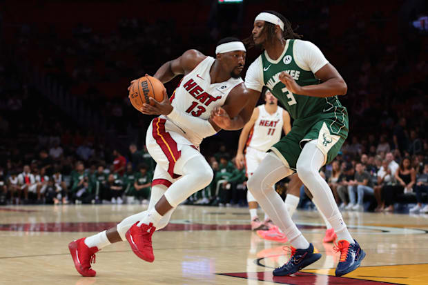Miami Heat center Bam Adebayo drives to the basket against Milwaukee Bucks center Myles Turner.