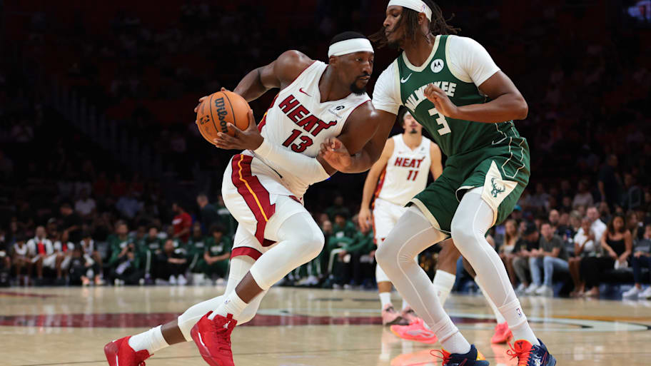 Miami Heat center Bam Adebayo drives to the basket against Milwaukee Bucks center Myles Turner.