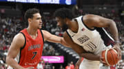 Jul 10, 2024; Las Vegas, Nevada, USA; Canada forward Dwight Powell (7) guards USA forward Joel Embiid (11) in the first quarter of the USA Basketball Showcase at T-Mobile Arena. Mandatory Credit: Candice Ward-USA TODAY Sports