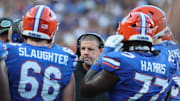 Nov 16, 2024; Gainesville, Florida, USA; Florida Gators head coach Billy Napier huddles up with teammates against the LSU Tigers during the first half at Ben Hill Griffin Stadium. Mandatory Credit: Kim Klement Neitzel-Imagn Images