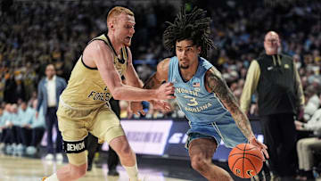 North Carolina guard Elliot Cadeau drives on Wake Forest guard Cameron Hildreth 