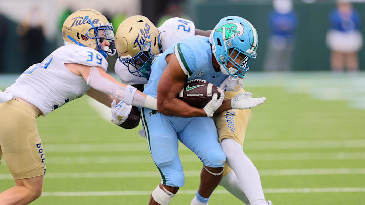 Nov 11, 2023; New Orleans, Louisiana, USA; Tulsa Golden Hurricane safety Dayne Hodge (39) and linebacker Julien Simon (24) tackle Tulane Green Wave running back Makhi Hughes (21) in the fourth quarter at Yulman Stadium.