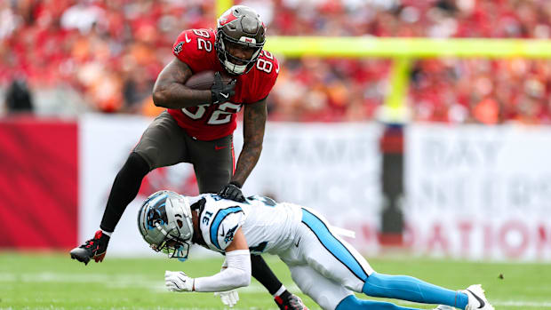 Tampa Bay Buccaneers tight end Devin Culp (82) holds off Carolina Panthers cornerback Caleb Farley (31).