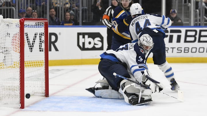 Apr 27, 2025; St. Louis, Missouri, USA; Winnipeg Jets goaltender Connor Hellebuyck (37) gives up a goal to St. Louis Blues defenseman Tyler Tucker (not pictured) during the second period in game four of the first round of the 2025 Stanley Cup Playoffs at Enterprise Center. Mandatory Credit: Jeff Le-Imagn Images