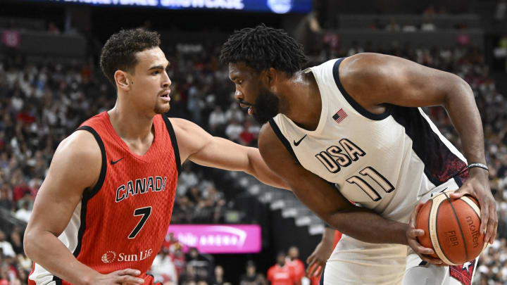 Jul 10, 2024; Las Vegas, Nevada, USA; Canada forward Dwight Powell (7) guards USA forward Joel Embiid (11) in the first quarter of the USA Basketball Showcase at T-Mobile Arena. Mandatory Credit: Candice Ward-USA TODAY Sports