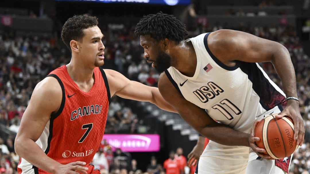 Jul 10, 2024; Las Vegas, Nevada, USA; Canada forward Dwight Powell (7) guards USA forward Joel Embiid (11) in the first quarter of the USA Basketball Showcase at T-Mobile Arena. Mandatory Credit: Candice Ward-USA TODAY Sports