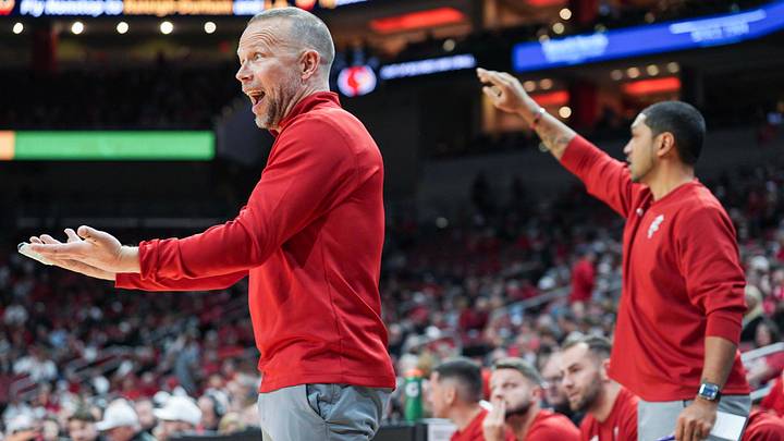 Louisville Cardinals head coach Pat Kelsey, left, yells from the sidelines as the Cards take on Eastern Michigan Nov. 24, 2025 at the KFC Yum! Center in Louisville, Kentucky. At right is assistant coach Peyton Siva, former star player at UofL.