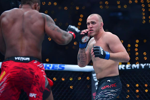Jailton Almeida (red gloves) fights Serghei Spivac (blue gloves) during UFC 311 at Intuit Dome. 
