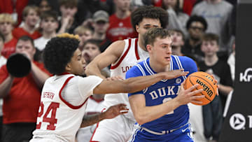 Dec 8, 2024; Louisville, Kentucky, USA;  Duke basketball guard Cooper Flagg (2) looks to pass under the pressure of Louisville Cardinals guard Chucky Hepburn (24) during the second half at KFC Yum! Center. Duke defeated Louisville 76-65. 