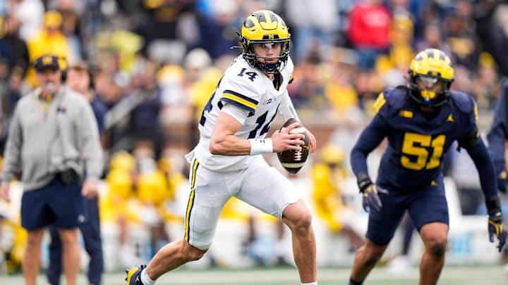 Michigan quarterback Tommy Carr (14) runs the ball during the spring game at Michigan Stadium in Ann Arbor on Saturday, April 18, 2026.
