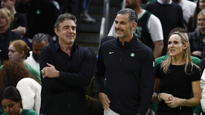 Apr 4, 2025; Boston, Massachusetts, USA; Bill Chisholm, center, who leads a group that is buying the Boston Celtics, stands with current owner Wyc Grousbeck and Chisholm’s wife, Kimberly Chisholm before the game between the Boston Celtics and the Phoenix Suns at TD Garden. Mandatory Credit: Winslow Townson-Imagn Images