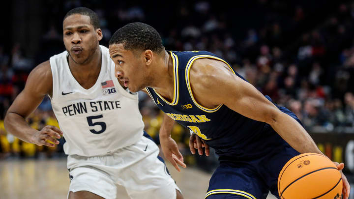 Michigan guard Nimari Burnett (4) dribbles against Penn State guard Jameel Brown (5) during the first half of the First Round of Big Ten tournament at Target Center in Minneapolis, Minn. on Wednesday, March 13, 2024.