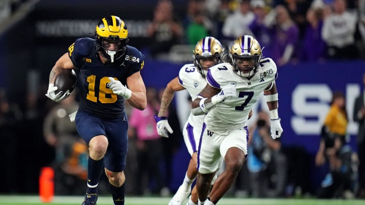 Jan 8, 2024; Houston, TX, USA; Michigan Wolverines tight end Colston Loveland (18) runs the ball after a catch against Washington Huskies cornerback Dominique Hampton (7) during the fourth quarter in the 2024 College Football Playoff national championship game at NRG Stadium. Mandatory Credit: Kirby Lee-USA TODAY Sports