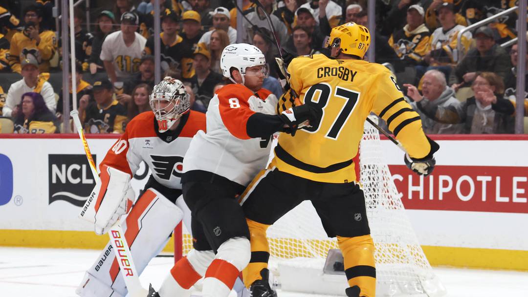 Apr 18, 2026; Pittsburgh, Pennsylvania, USA; Philadelphia Flyers defenseman Cam York (8) checks Pittsburgh Penguins center Sidney Crosby (87) in front of Flyers goaltender Dan Vladar (80) during the first period against in game one of the first round of the 2026 Stanley Cup Playoffs at PPG Paints Arena.