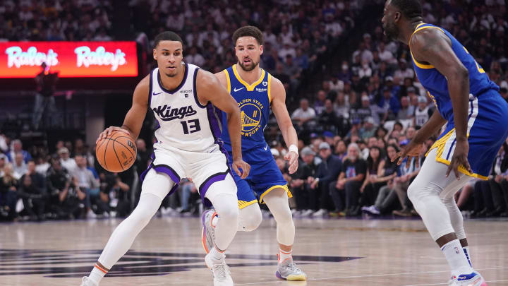 Apr 16, 2024; Sacramento, California, USA; Sacramento Kings forward Keegan Murray (13) dribbles the ball in front of Golden State Warriors guard Klay Thompson (11) in the first quarter during a play-in game of the 2024 NBA playoffs at the Golden 1 Center. Mandatory Credit: Cary Edmondson-USA TODAY Sports