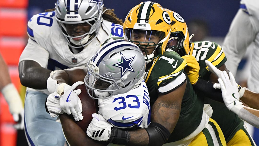 Green Bay Packers defensive end Micah Parsons (1) tackles Dallas Cowboys running back Javonte Williams (33) in the third quarter at AT&T Stadium.