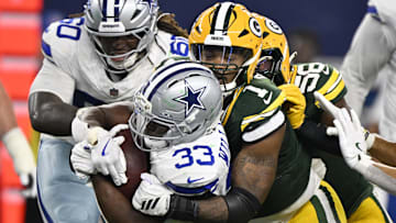Green Bay Packers defensive end Micah Parsons (1) tackles Dallas Cowboys running back Javonte Williams (33) in the third quarter at AT&T Stadium.