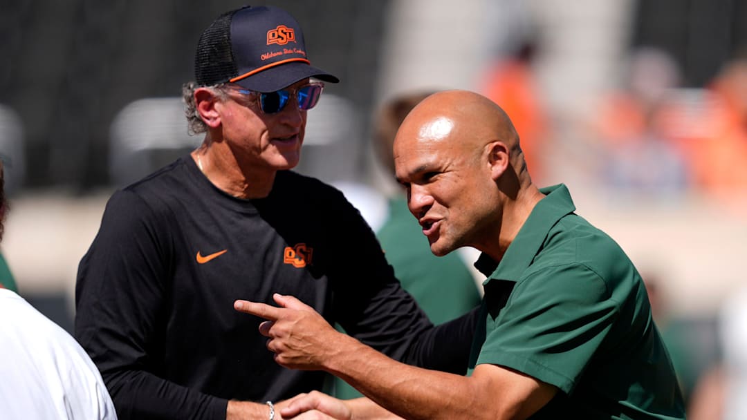 Oklahoma State Interim Head Coach/Offensive Coordinator Doug Meacham and Dave Aranda talk before the college football game between the Oklahoma State Cowboys and the Baylor Bears at Boone Pickens Stadium in Stillwater, Okla., Saturday, Sept. 27, 2025. Oklahoma State Interim Head Coach/Offensive Coordinator Doug Meacham and Dave Aranda talk before the college football game between the Oklahoma State Cowboys and the Baylor Bears at Boone Pickens Stadium in Stillwater, Okla., Saturday, Sept. 27, 2025.