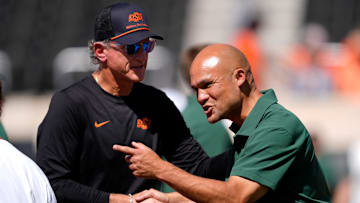 Oklahoma State Interim Head Coach/Offensive Coordinator Doug Meacham and Dave Aranda talk before the college football game between the Oklahoma State Cowboys and the Baylor Bears at Boone Pickens Stadium in Stillwater, Okla., Saturday, Sept. 27, 2025.