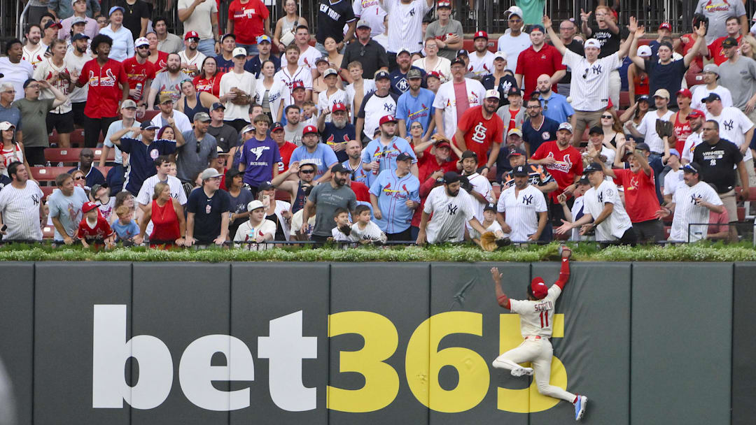 Aug 16, 2025; St. Louis, Missouri, USA;  St. Louis Cardinals center fielder Victor Scott II (11) leaps and smashes into the wall but is unable to catch a solo home run hit by New York Yankees designated hitter Aaron Judge (not pictured) during the third inning at Busch Stadium. Mandatory Credit: Jeff Curry-Imagn Images