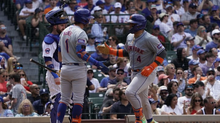 Jun 22, 2024; Chicago, Illinois, USA; New York Mets catcher Francisco Alvarez (4) is greeted by second baseman Jeff McNeil (1) after hitting a home run against the Chicago Cubs during the fifth inning at Wrigley Field.
