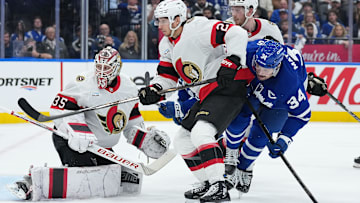 Apr 29, 2025; Toronto, Ontario, CAN; Toronto Maple Leafs center Auston Matthews (34) battles with Ottawa Senators center Dylan Cozens (24) in the third period during game five of the first round of the 2025 Stanley Cup Playoffs at Scotiabank Arena. Mandatory Credit: Nick Turchiaro-Imagn Images