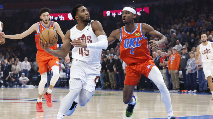 Nov 8, 2023; Oklahoma City, Oklahoma, USA; Cleveland Cavaliers guard Donovan Mitchell (45) drives to the basket against Oklahoma City Thunder guard Shai Gilgeous-Alexander (2) during the first quarter at Paycom Center. Mandatory Credit: Alonzo Adams-USA TODAY Sports