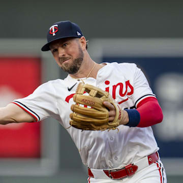 Minnesota Twins second baseman Kyle Farmer (12) throws to first base for an out against the Los Angeles Angels in the second inning at Target Field in Minneapolis on Sept. 9, 2024.