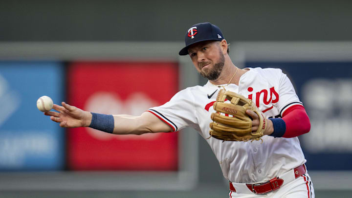 Minnesota Twins second baseman Kyle Farmer (12) throws to first base for an out against the Los Angeles Angels in the second inning at Target Field in Minneapolis on Sept. 9, 2024.