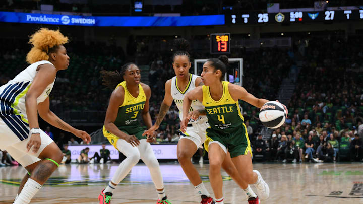 Jun 3, 2025; Seattle, Washington, USA; Seattle Storm guard Skylar Diggins (4) dribbles the ball while defended by Dallas Wings guard Aziaha James (10) during the first half at Climate Pledge Arena. 