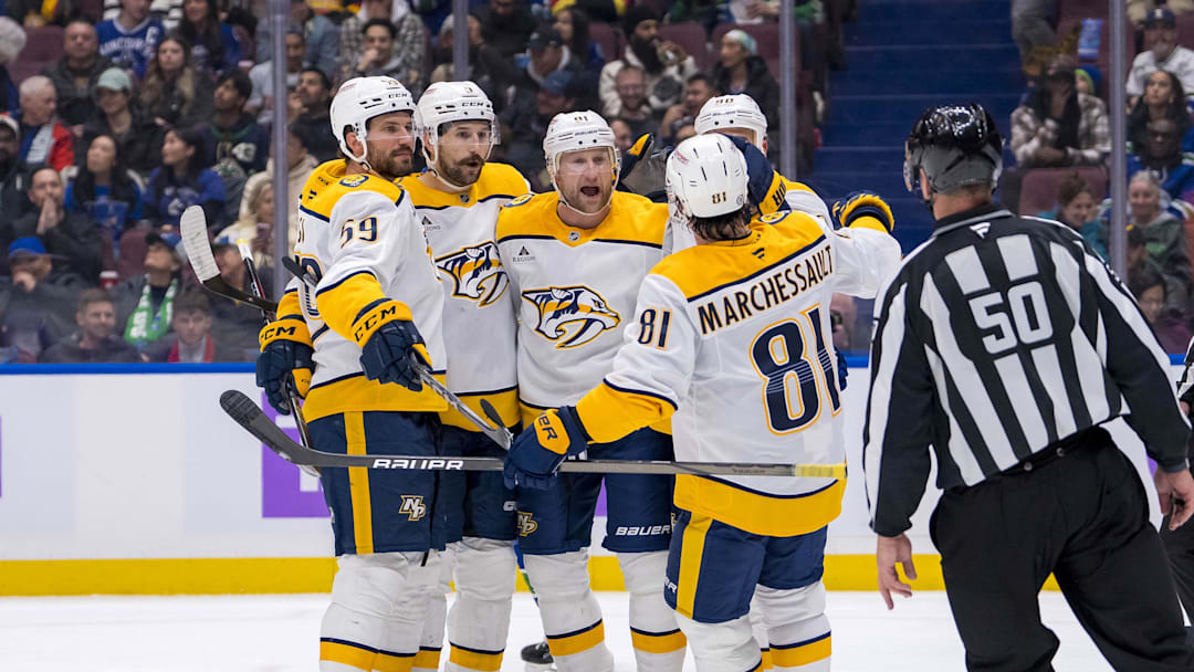 Nov 17, 2024; Vancouver, British Columbia, CAN; Dejected Vancouver Canucks forward Elias Pettersson (40) watches as Nashville Predators defenseman Roman Josi (59) and forward Filip Forsberg (9) and forward Steven Stamkos (91) and forward Ryan O'Reilly (90) and forward Jonathan Marchessault (81) celebrate Stamkos’ second goal against the Vancouver Canucks during the second period at Rogers Arena. Mandatory Credit: Bob Frid-Imagn Images
