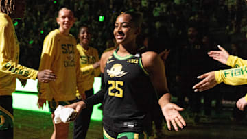 Oregon’s Deja Kelly, center, takes the floor during team introductions at Matthew Knight Arena in Eugene.