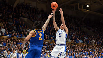 Jan 7, 2025; Durham, North Carolina, USA; Duke Blue Devils guard Tyrese Proctor (5) shoots over Pitt Panthers forward Cameron Corhen (2) during the second half at Cameron Indoor Stadium. Mandatory Credit: Rob Kinnan-Imagn Images