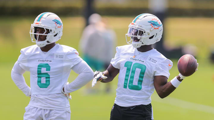 Miami Dolphins wide receiver Tyreek Hill tosses a football as Malik Washington looks on during mandatory NFL minicamp Miami Dolphins wide receiver Tyreek Hill tosses a football as Malik Washington looks on during mandatory NFL minicamp