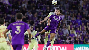 Nov 30, 2024; Orlando, Florida, USA; Orlando City forward Ramiro Enrique (7) battles for a header against New York Red Bulls defender Dylan Nealis (12) during the first half in the 2024 MLS Cup Eastern Conference Final match at Inter&Co Stadium. Mandatory Credit: Mike Watters-Imagn Images